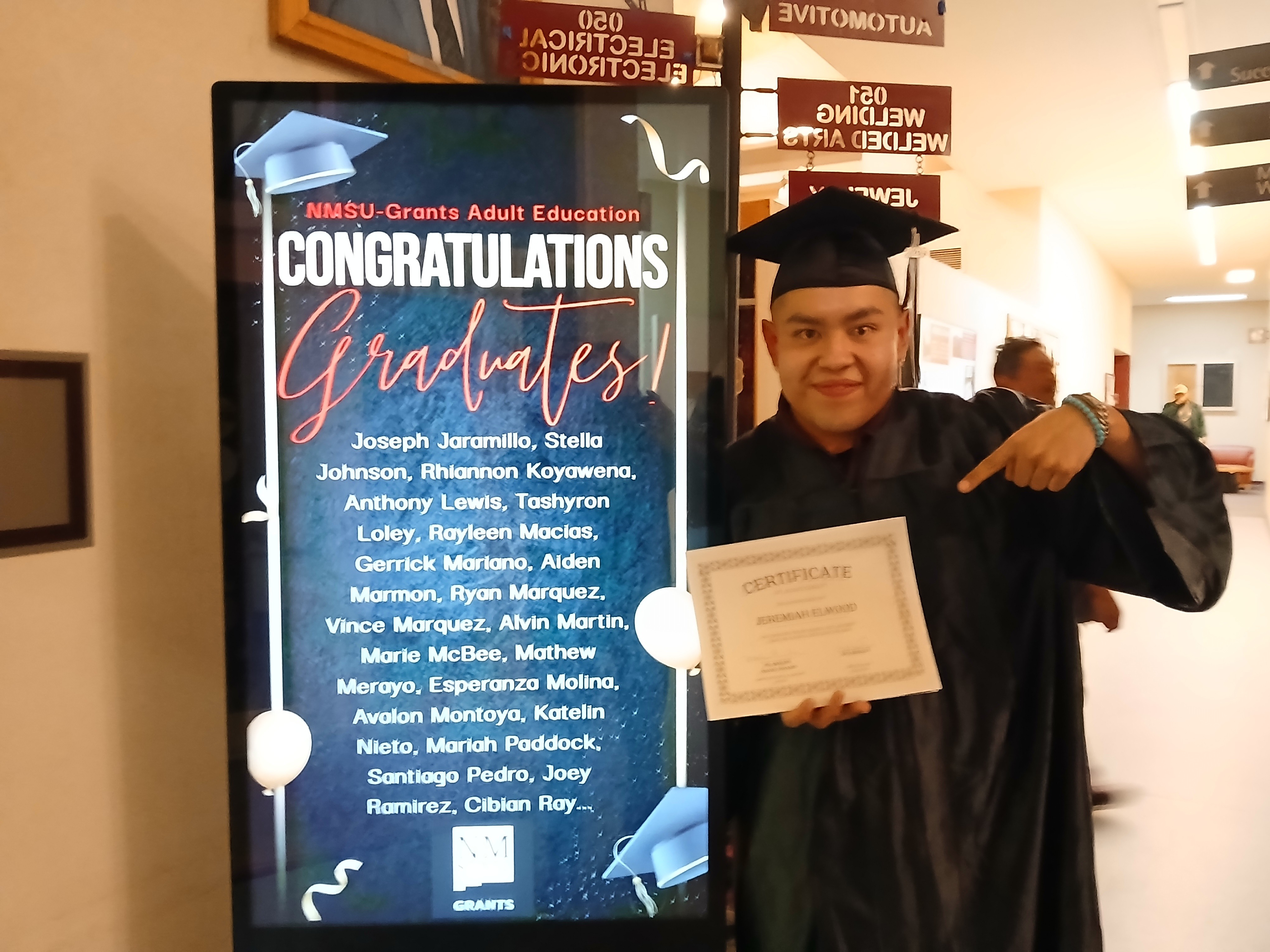 Graduate with sign